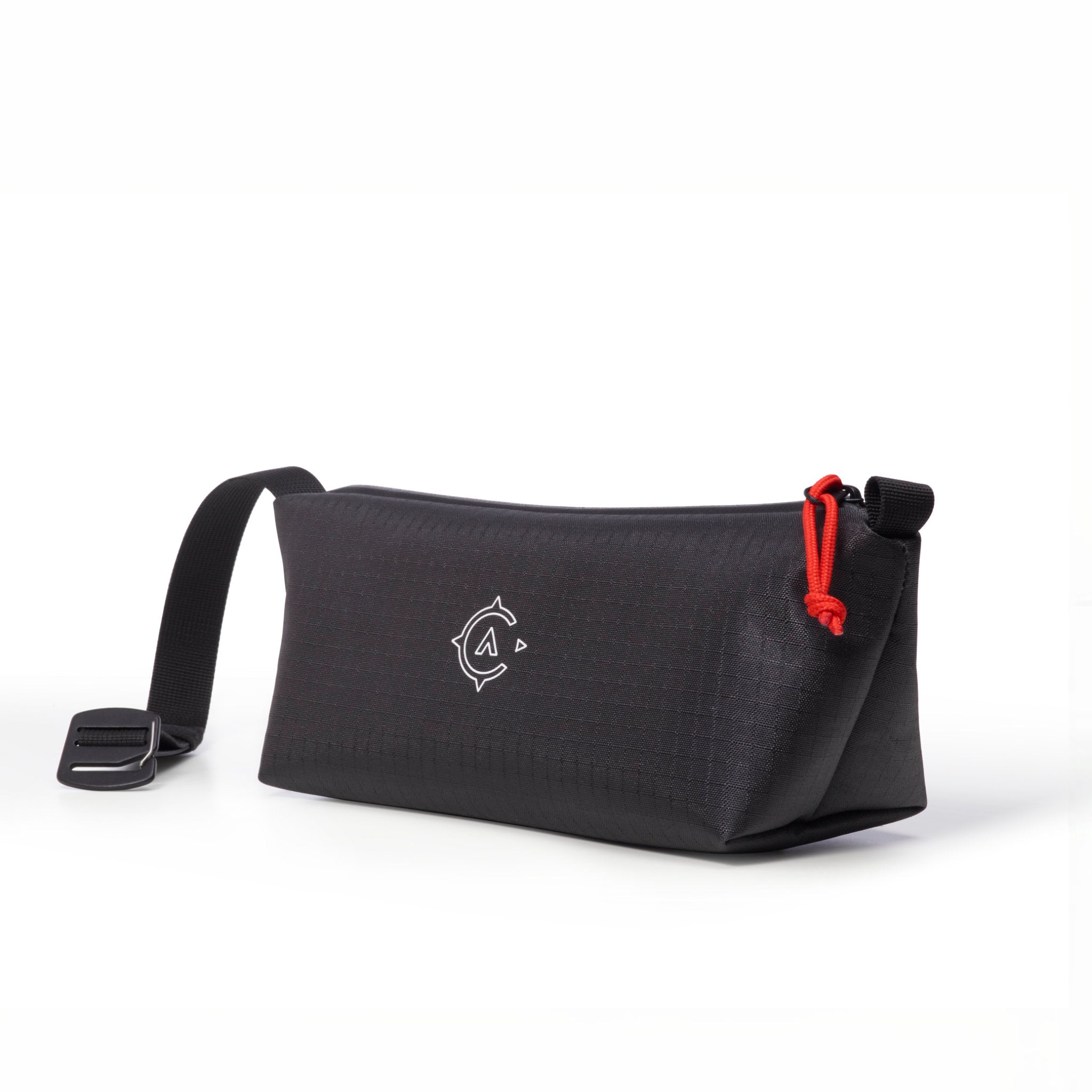 Black washbag with a strap and red zipper pull on a white background
