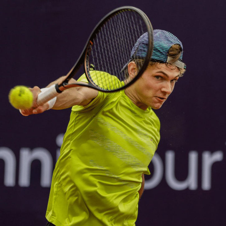Cancha founder Jack Oswald competing on the tennis court