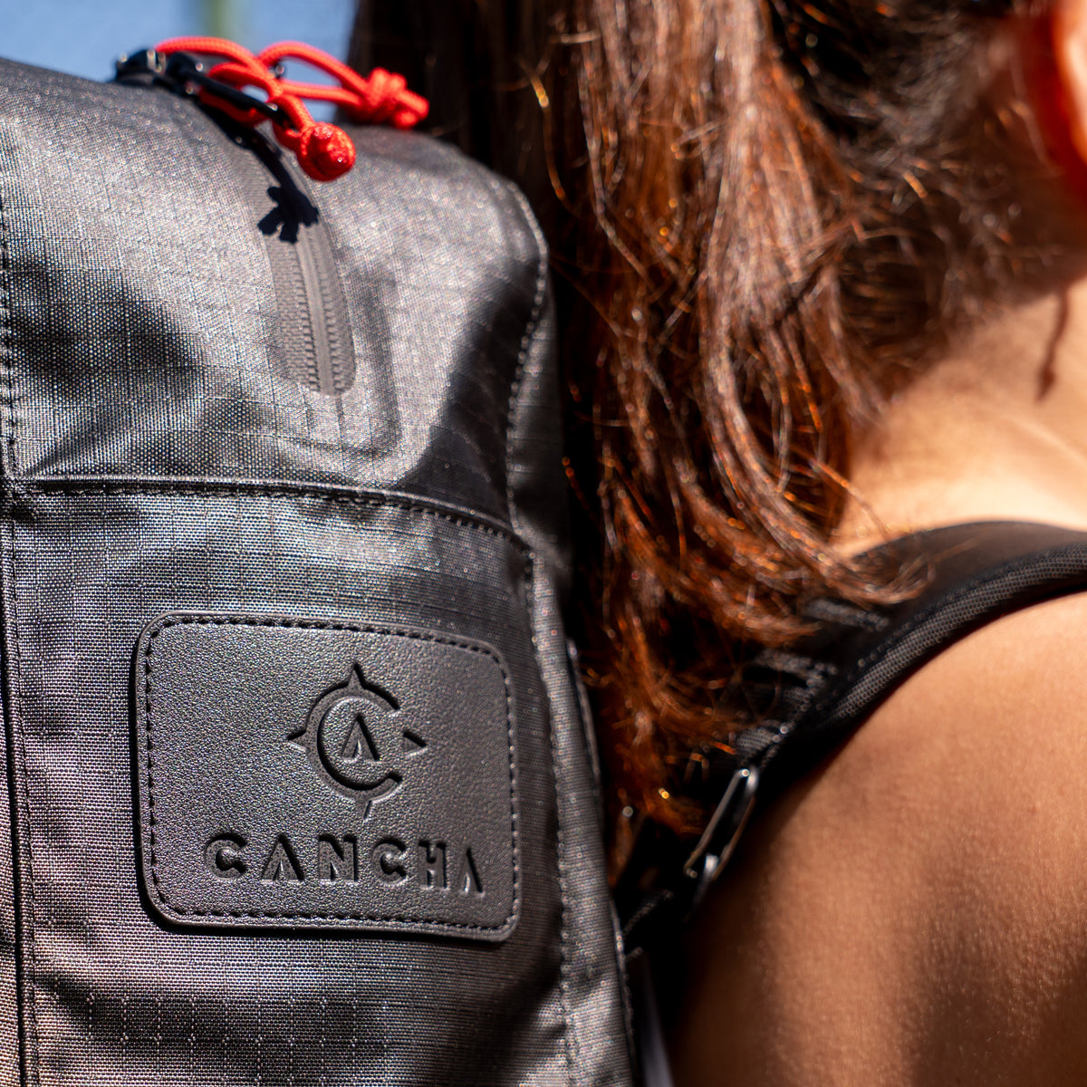 Close-up of the Racquet Bag Voyager’s ripstop fabric and Cancha logo