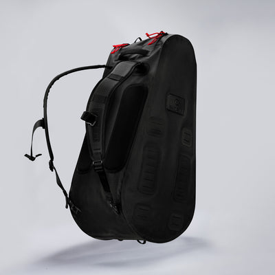 Black Cancha tennis backpack with red accents on a white background